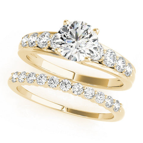 Yellow gold Princess Brilliant Solitaire with Side Stones on a Pave Band and Four-Prong Setting