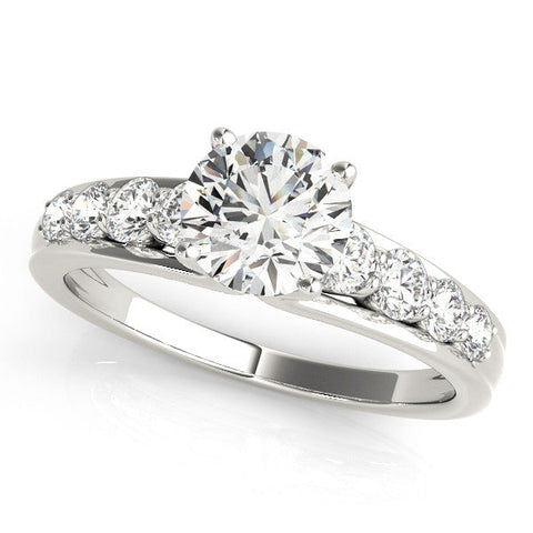 White gold Princess Brilliant Solitaire with Side Stones on a Pave Band and Four-Prong Setting