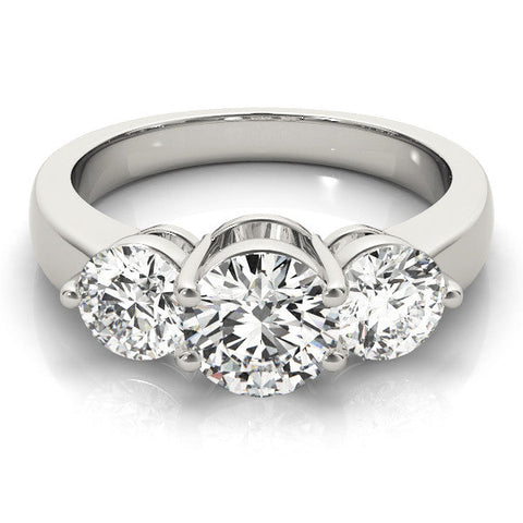 Platinum Three-Stone Round Brilliant Cut Solitaire Ring with Prong Setting on a Classic Band