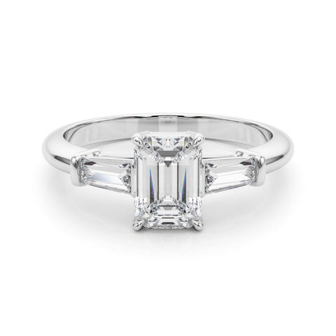 Platinum Heart Cut Diamond Ring with Tapered Baguette Side Stones on a Platinum Band with Four-Prong Setting