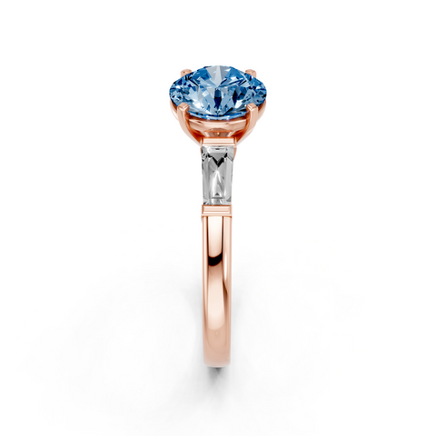 Rose gold Fancy Blue Round  Solitaire with Tapered Baguette Side Stones on a Classic Band with Four-Prong Setting