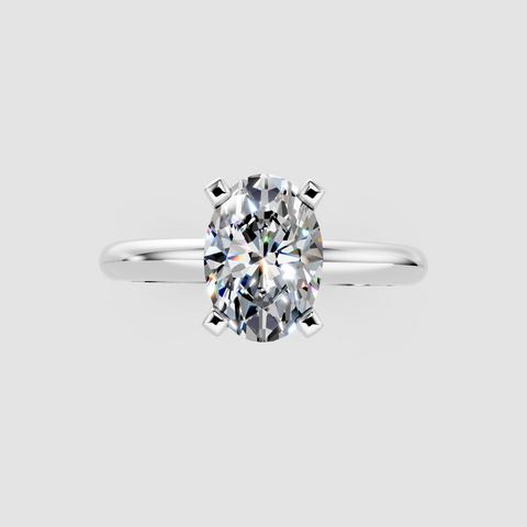 Platinum Oval Cut Solitaire Engagement Ring with Round Band and Four-Prong Setting