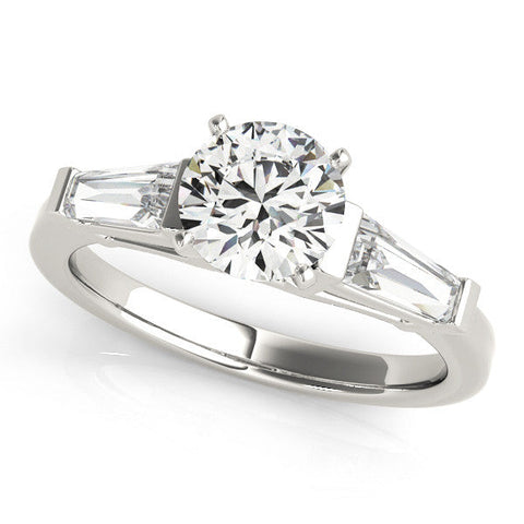 Platinum Round Cut Diamond Solitaire Ring with Tapered Baguette Accents and Four-Prong Setting