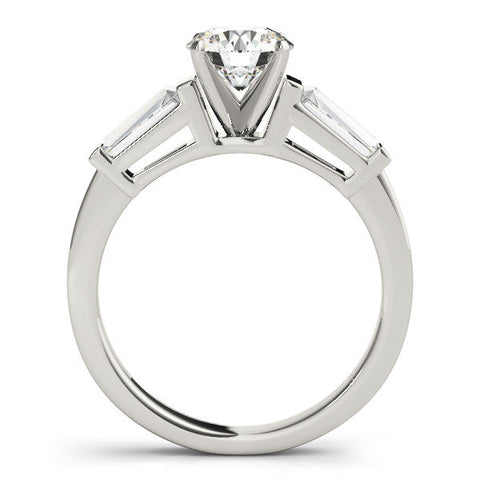 Platinum Round Cut Diamond Solitaire Ring with Tapered Baguette Accents and Four-Prong Setting