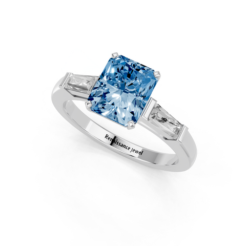 White gold Fancy Blue Radiant  Solitaire with Tapered Baguette Side Stones on a Classic Band with Four-Prong Setting
