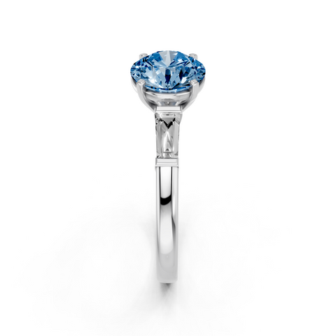 Platinum Fancy Blue Round  Solitaire with Tapered Baguette Side Stones on a Classic Band with Four-Prong Setting