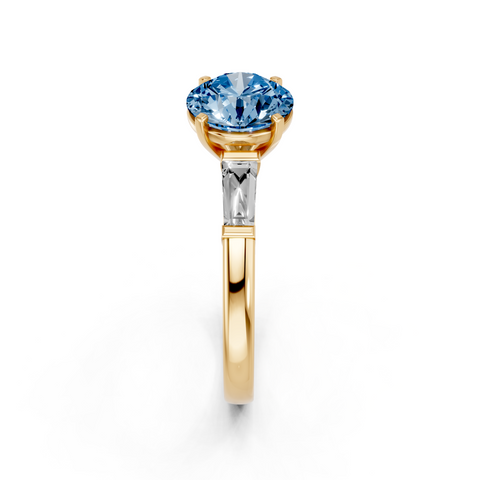 Yellow gold Fancy Blue Round  Solitaire with Tapered Baguette Side Stones on a Classic Band with Four-Prong Setting